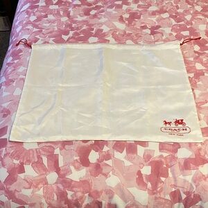 Coach White dust bag with Red Accents and drawstring.